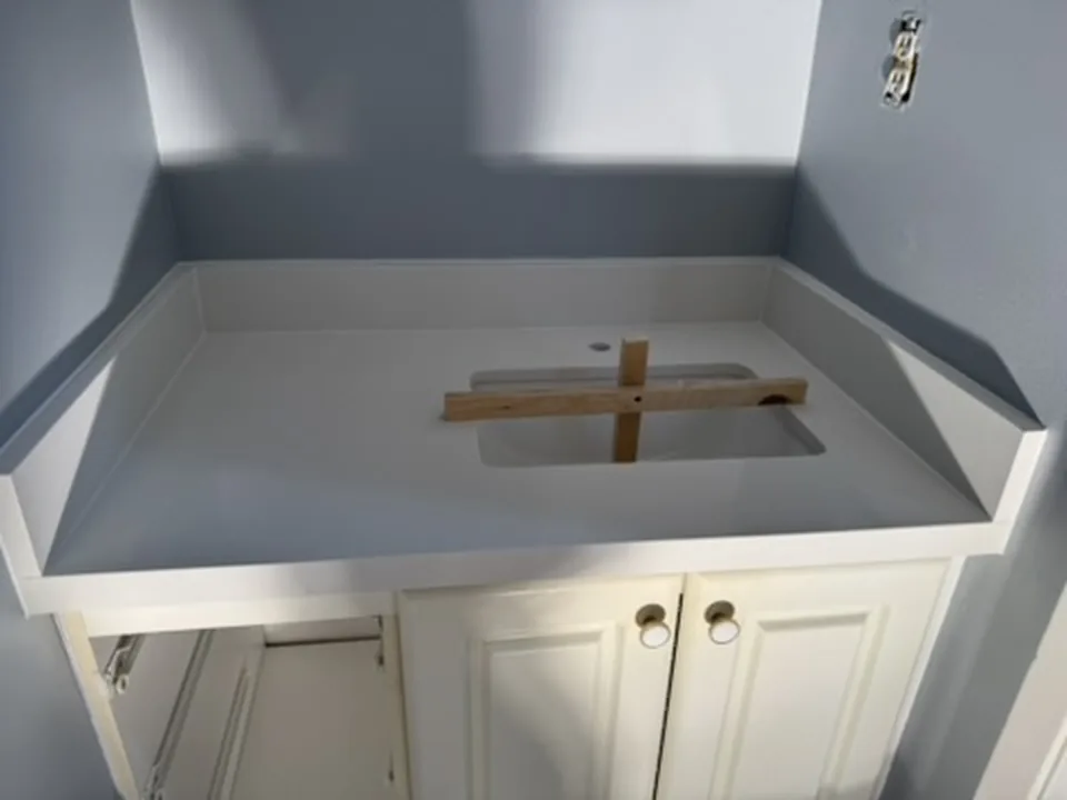 The same cabinet with a white quartz vanity top, a 4-inch quartz splash on the back and both side walls and an undermount sink cut-out, Aurora Ontario