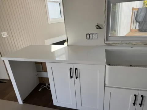 The end of the peninsula in white quartz next to the farmhouse sink, Schomberg Ontario