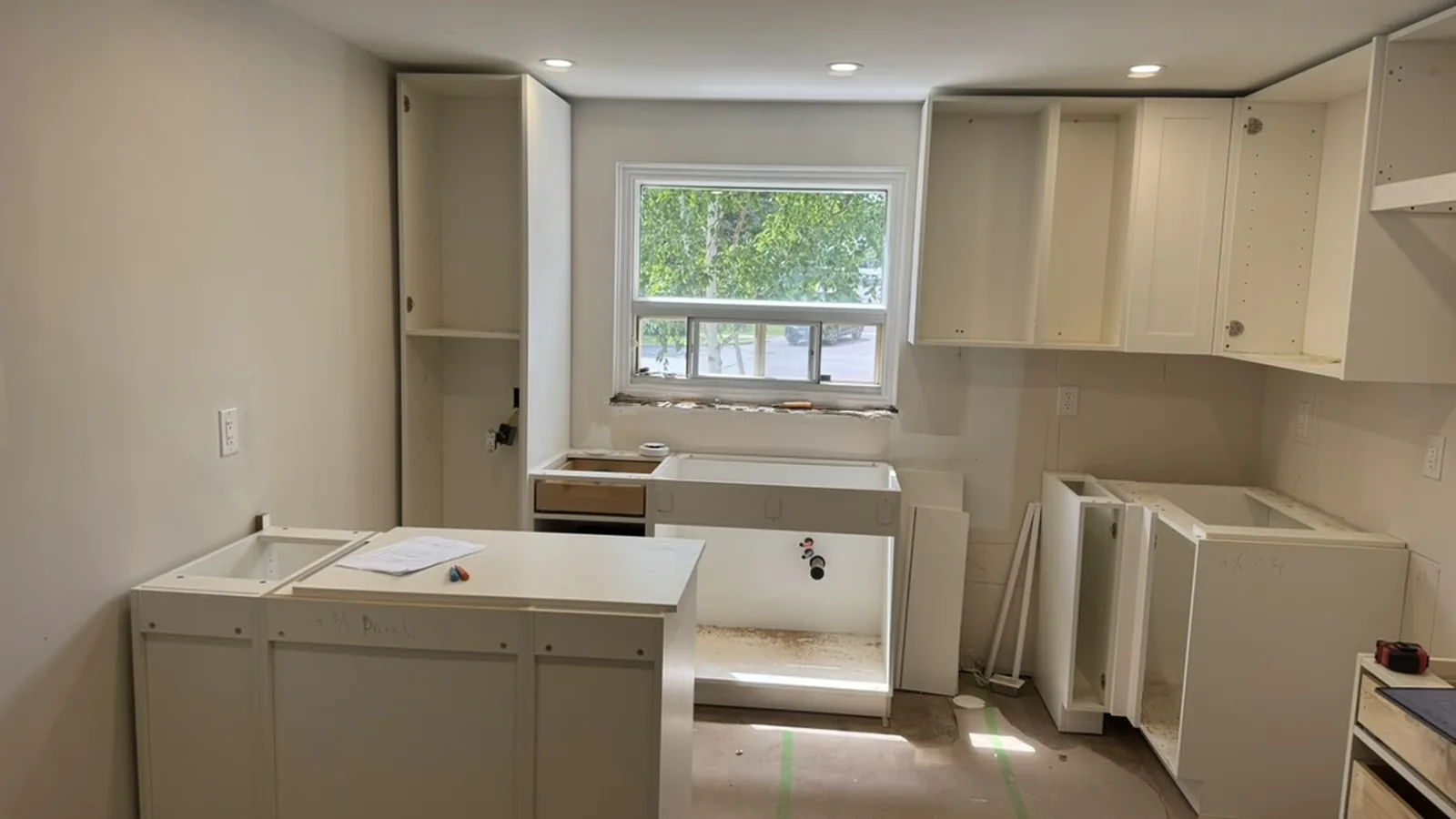 Tall pantry box, sink base under the window and peninsula cabinets in place before the quartz, Aurora Ontario
